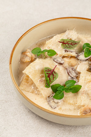 Portion of gourmet ravioli with cream sauceの写真素材