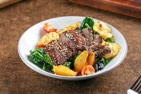 Roast beef dish with vegetables garnishの写真素材