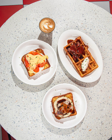 Flat lay of table with brunch toasts and waffleの写真素材