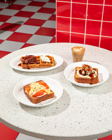 Served table with brunch toasts and waffleの写真素材
