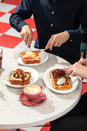 Dining in cafe with toasts and savory waffleの写真素材