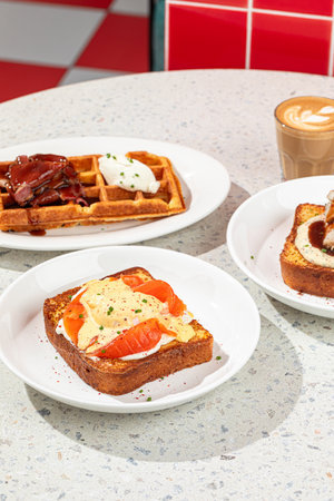 Served table with brunch toasts and waffleの写真素材