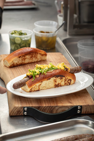 Preparing hot dogs in diner kitchen counterの写真素材