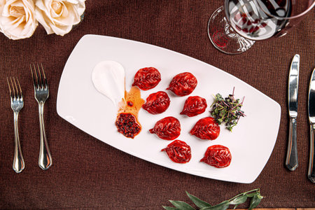 Gourmet red colored dumplings with sauceの写真素材