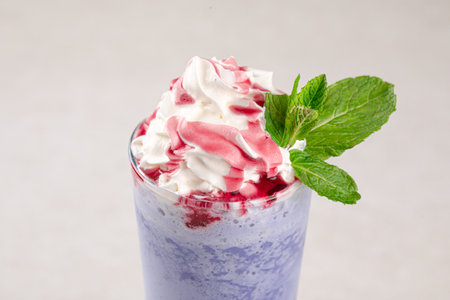 Portion of blueberry milkshake with whipped creamの写真素材