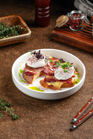 Breakfast with bacon and poached egg on toastの写真素材