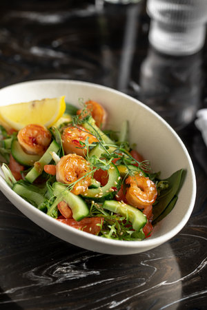 Portion of salad with fresh vegetables and shrimpの写真素材