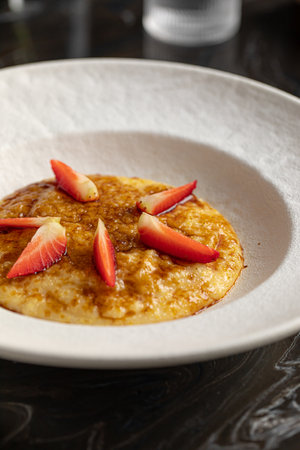 Portion of corn porridge with strawberriesの写真素材