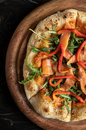 Portion of pizza with salmon and baked pepperの写真素材