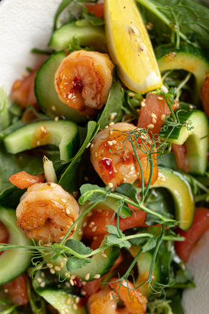 Portion of salad with fresh vegetables and shrimpの写真素材