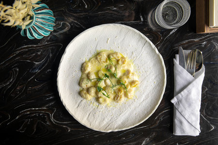 Portion of potato gnocchi with creamy sauceの写真素材