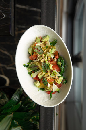 Portion of salad with avocado and orangesの写真素材