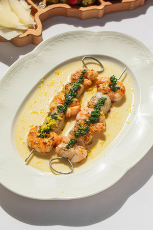 Portion of grilled shrimp skewers with sauceの写真素材