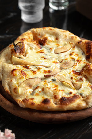 Portion of italian pizza with cheese and pearsの写真素材