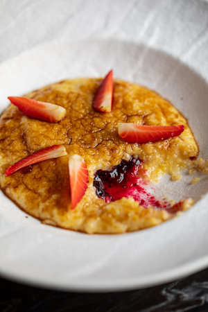 Portion of corn porridge with strawberriesの写真素材