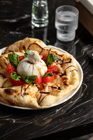 Portion of italian style focaccia with burattaの写真素材