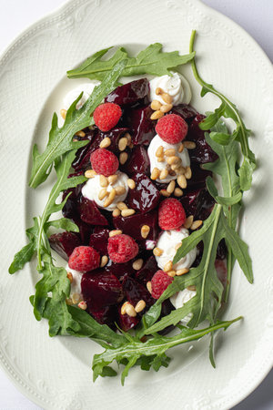 Portion of beet salad with cheese and arugulaの写真素材