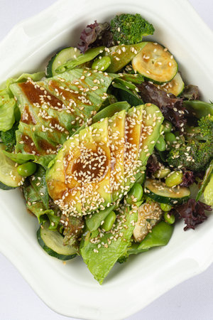Portion of green salad with avocadoの写真素材