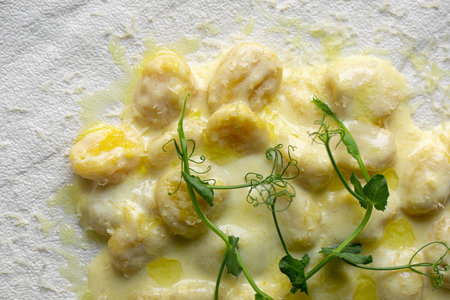 Portion of potato gnocchi with creamy sauceの写真素材