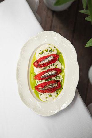 Portion of baked pepper appetizer with small fish