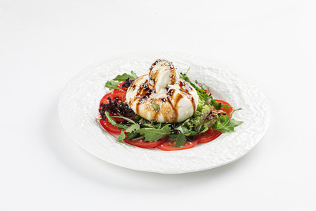 Portion of burrata salad with tomatoes and arugulaの写真素材