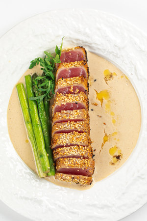 Gourmet grilled tuna with asparagus and sauceの写真素材