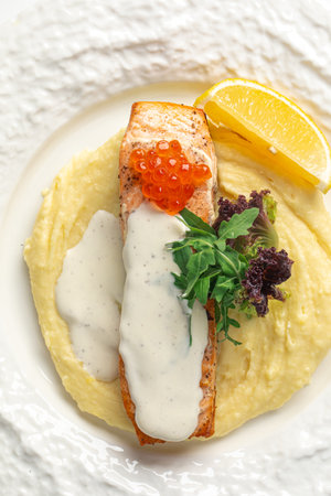 Portion of salmon fillet steak with creamy sauceの写真素材