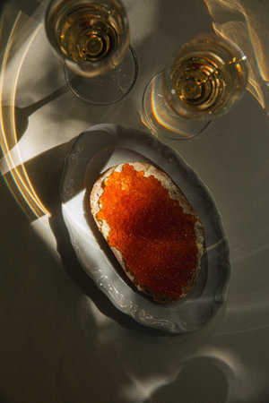 Bread with butter and red caviar with champagneの写真素材