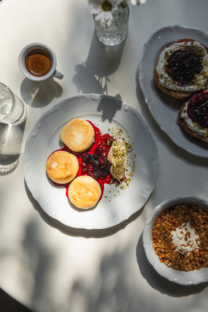 Sweet breakfast with syrniki granola and espresso