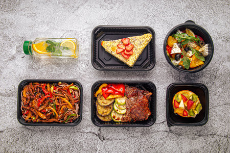 Fitness meal plan in black containers with drink