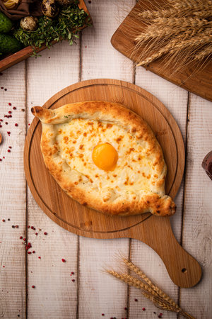Khachapuri with egg on wooden boardの写真素材