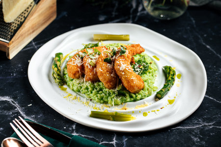 Green risotto with fried shrimp and asparagusの写真素材