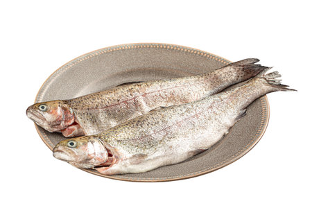 Isolated portion of two raw whole fish on plate