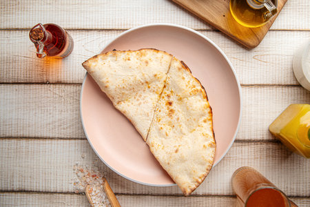 Warm homemade flatbread folded on rustic plateの写真素材