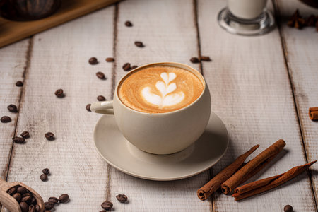 Creamy latte with foam art on rustic tableの写真素材