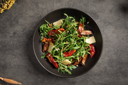 Fresh arugula salad with beef and sundried tomatoesの写真素材
