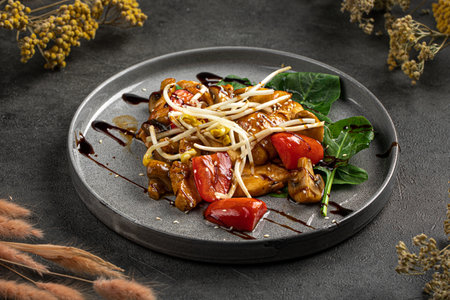 Glazed chicken stir fry with peppers plateの写真素材