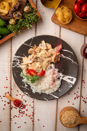 Chicken fricassee with rice and sauceの写真素材