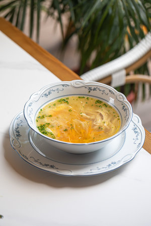 Classic chicken noodle soup with herbsの写真素材