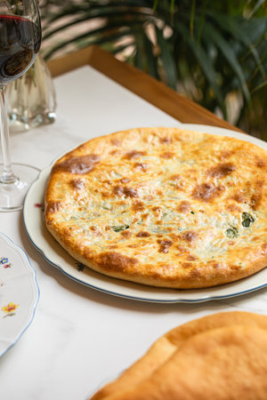 Georgian khachapuri cheese bread on restaurant table