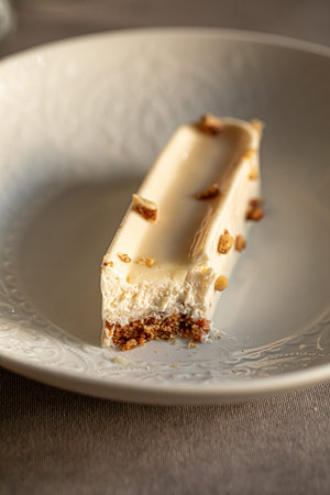 Sliced creamy dessert with nut glaze