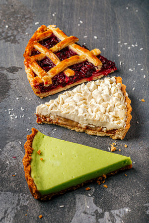 Three assorted pie slices on dark backgroundの写真素材