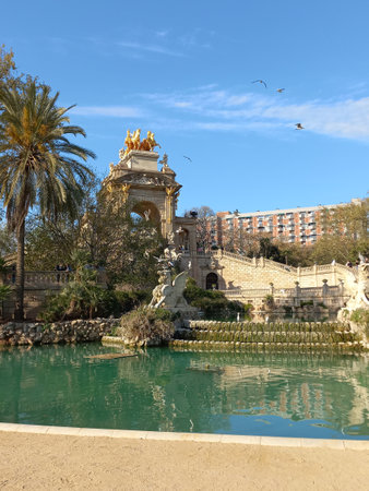 Barcelona Catalonia Spain. April 10 2025. Ornate fountain Cascada Monumental featuring classical statues golden quadriga and lush landscaping in Parc de la Ciutadellaの写真素材