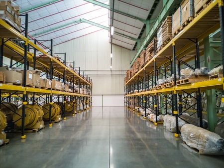 Warehouse with stacked yellow shelving and clean floorのeditorial素材