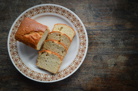 banana cake on dish and wood background (left)の写真素材