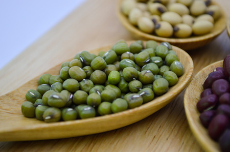 Mung bean in wooden spoon on cutting board