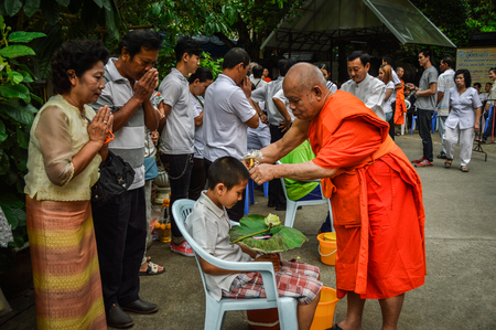 Chiang Rai, Thailand - April 1, 2017 : Ordination ceremony at Wat Phra Keaw. Monk cut boy hairのeditorial素材