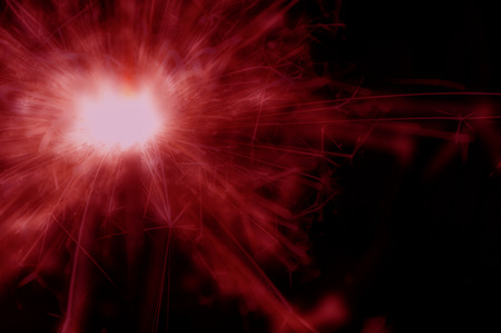 Christmas sparkler holiday background for Christmas, new year and celebrate event. Red color abstract art work.の写真素材