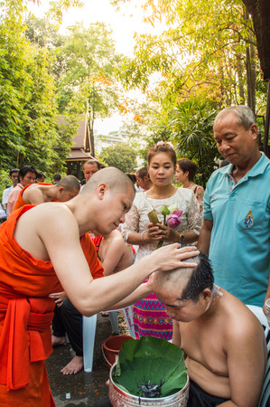 Chiang Rai, Thailand - April 1, 2018 : The Ordination Ceremony of the 2018 Ordination Program at Wat Phra Kaew Chiang Rai, hair shaving before ordination.のeditorial素材