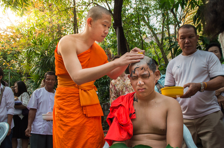 Chiang Rai, Thailand - April 1, 2018 : The Ordination Ceremony of the 2018 Ordination Program at Wat Phra Kaew Chiang Rai, hair shaving before ordination.のeditorial素材